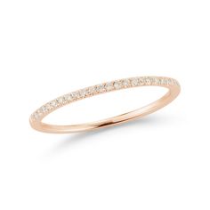 a rose gold ring with white diamonds on the side and a thin band around it