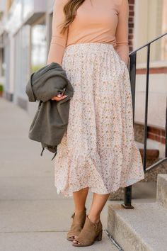 We cannot get over how stylish this skirt is! The feminine floral print and tiered style fit makes such a cute, elegant look! Wear this skirt to any event and you are sure to receive compliments! We love tucking a blouse into this for a more elevated look or a basic or graphic tee for a casual feel! The best part of this skirt, it has POCKETS!Self: 100% PolyesterLining: 100% Polyester Light Floral Skirt, Dirndl, Comfy Feminine Style, How To Style Skirts Casual, Mid Size Modest Outfits, Cute Modest Skirt Outfits, Midi Skirt Outfit Modest, Cozy Feminine Outfits, Cute Skirt Outfits Modest