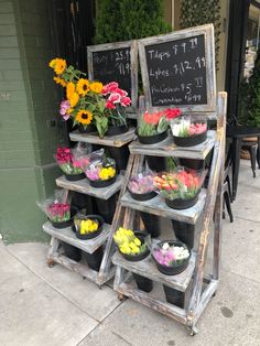 flowers are on display in front of a store