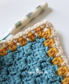 a crochet square with a crocheted toothbrush resting on top of it