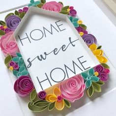 a home sweet home card with paper flowers in the shape of a hexagonal frame