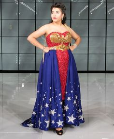 a woman in a red, white and blue dress stands with her hands on her hips