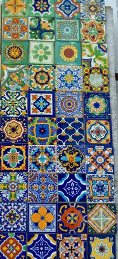 an assortment of colorful tiles on the ground