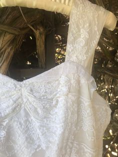 a white dress hanging on a clothes rack