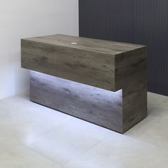 a large wooden bench sitting on top of a white floor next to a black wall