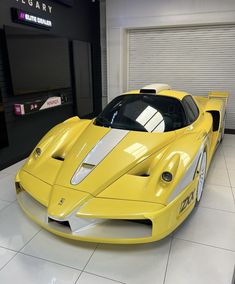 a yellow sports car parked in a garage