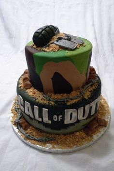 there is a cake that has been decorated to look like a camo helmet and boots