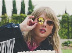 a woman with sunglasses and a flower in her eye