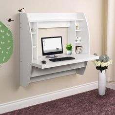 a white computer desk with a monitor and keyboard