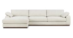 a white sectional couch with pillows on it's back and the seat folded out