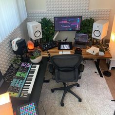 a computer desk topped with lots of musical equipment