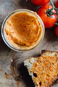 a bowl of hummus next to some tomatoes and bread with the words quickly preserve whip up butter