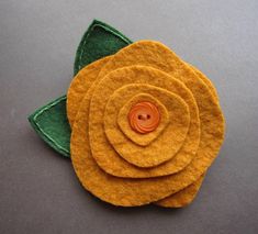 three felt flowers sitting on top of each other
