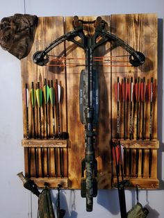 a wall mounted archery target rack with arrows