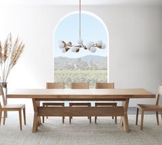 a dining room table and chairs with an arched window in the backround behind it