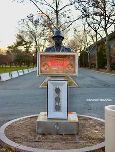 a statue of a man sitting in front of a traffic light