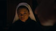 a woman in a nun outfit looking at the camera with an intense look on her face