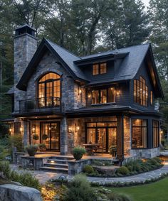 a large house with lots of windows and stone steps leading up to the front door