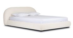 a bed with white sheets and pillows on it's headboard, in front of a white background