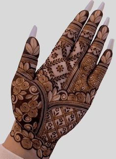 the hand is decorated with intricate designs