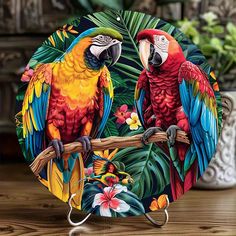 two colorful parrots are sitting on a branch with tropical leaves and flowers around them