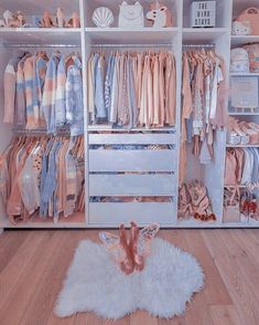 a white closet filled with lots of clothes