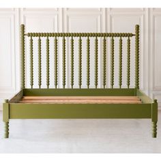 a green bed frame with wooden slats