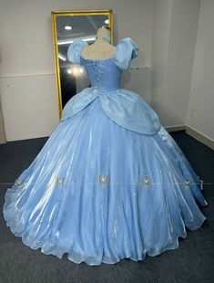 a blue ball gown on display in front of a mirror