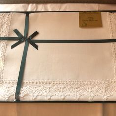 a white sheet with a green ribbon tied around it