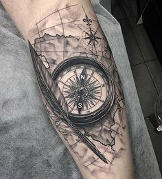 a man with a compass tattoo on his arm