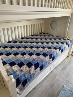 a bed with a blue and white checkered bedspread on top of it