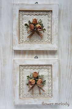 two white framed pictures with flowers on them