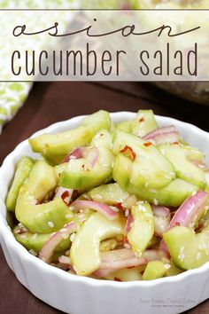 cucumber salad in a white bowl with red onions and celery on the side