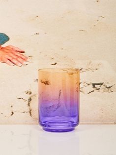 a purple glass sitting on top of a white counter