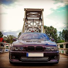 a purple car parked in front of a bridge