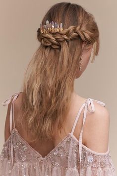 the back of a woman's head wearing a tiara with beads on it