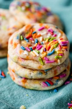 several cookies with sprinkles on a blue cloth