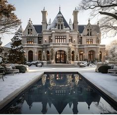 a large house with a pool in front of it and lots of snow on the ground