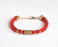 This red bracelet is great for stacking and looks fabulous on it's own too! It is made from knit cotton cord in bright red color and is soft and comfortable to wear. Cord has brass tube in the middle and rings on each side. Tube has industrial look with small imperfections which create special look. Bracelet closes at the back.You can find other colors and designs here: http://www.etsy.com/shop/LeiniJewelry?section_id=12137607Check other items in my shop http://www.etsy.com/shop/LeiniJewelry &gt Burgundy Bracelet, Bracelet Cord, Tube Bracelet, Brass Tube, Cotton Bracelet, Knit Bracelet, Red Bracelet, Bracelet Cordon, Coral Bracelet