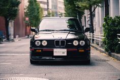 a black car is parked on the street