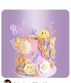 a pink cake decorated with smiley faces and flowers on it's side is the caption for bonnie
