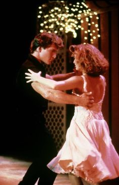 a man and woman dance together on stage