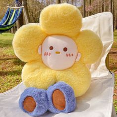 a yellow stuffed animal sitting on top of a white chair