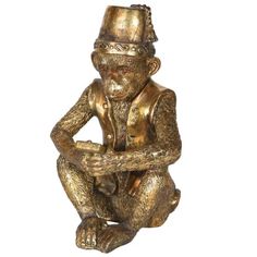 a gold colored statue of a monkey with a hat on its head and arms crossed