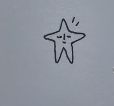 a star drawn on the side of a wall next to a toothbrush with its mouth open