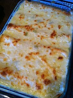 a casserole dish with cheese on top in a blue baking pan, ready to be eaten