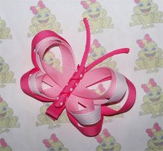 a close up of a pink bow on a wall