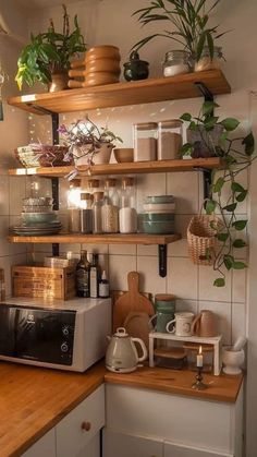 a kitchen with shelves filled with pots and pans on top of the countertop