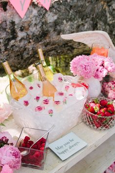 flowers and bottles of wine on a table