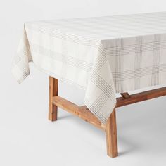 a table with a checkered cloth on it and a wooden frame around the edge